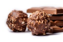 chocolate bonbons covered with nuts with chocolate bars
